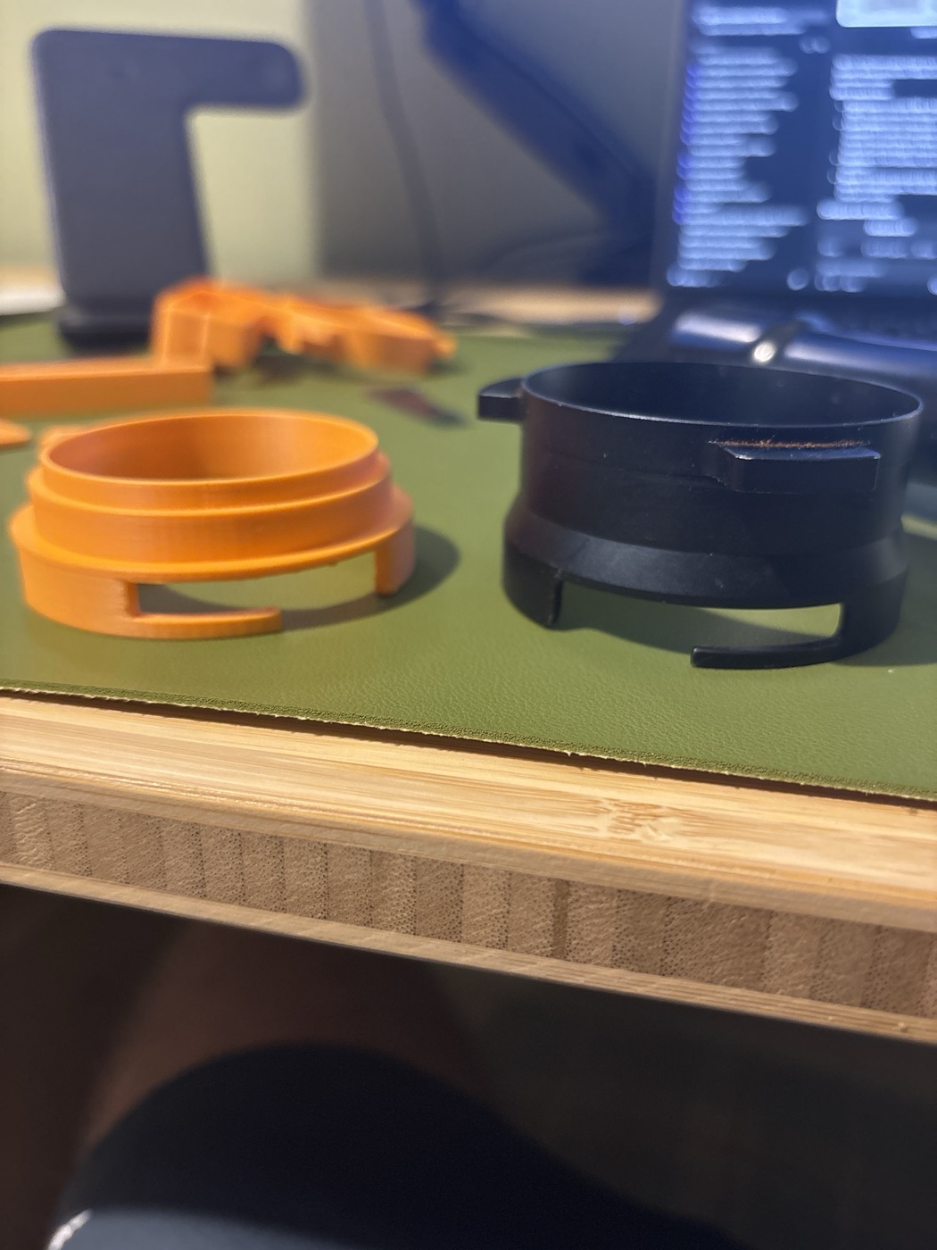 An orange printed sleeve next to the black dosing ring, their slots facing the camera