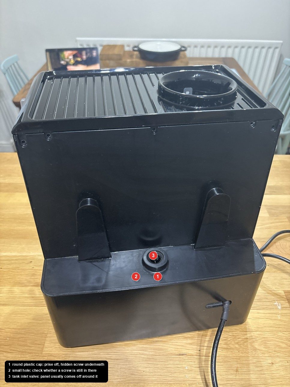 Rear of the machine with the tank off, the hidden screw cap marked