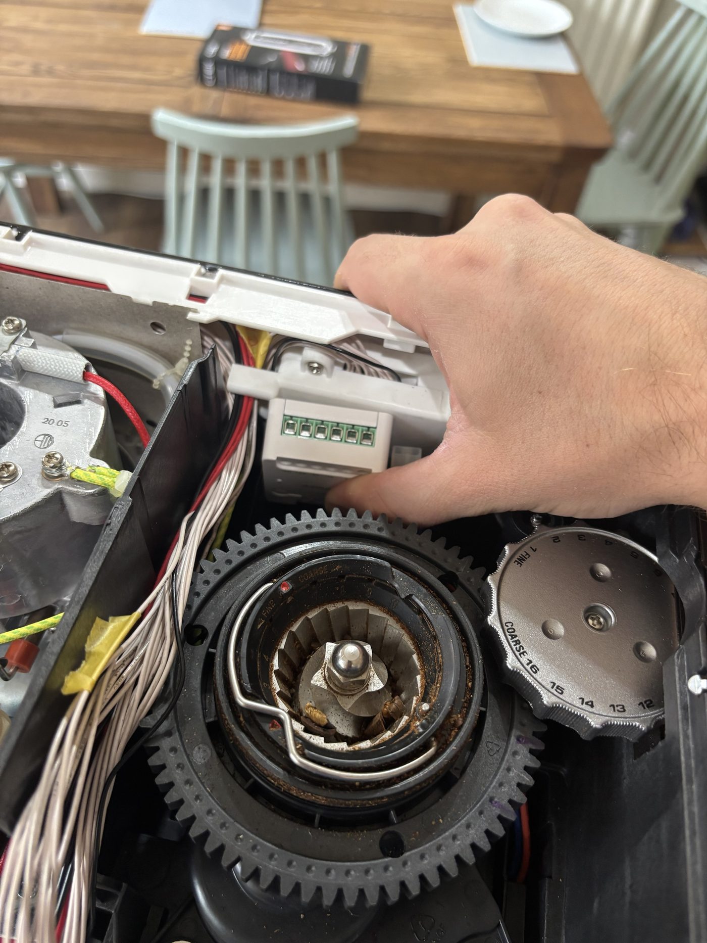 A relay held in the top compartment beside the grinder gear